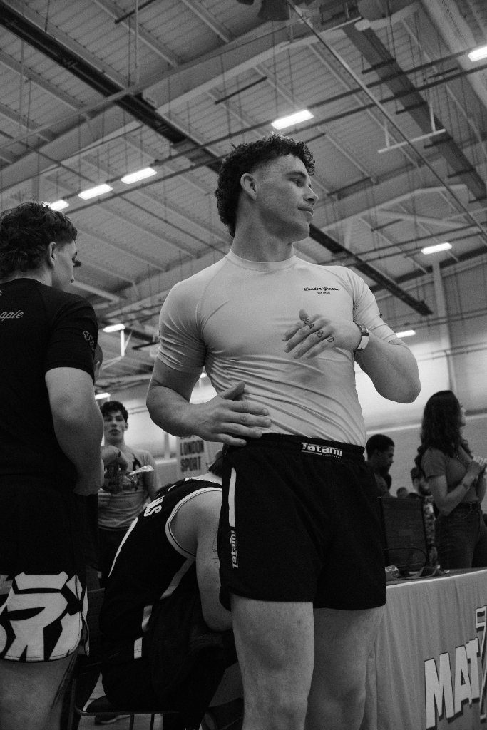 George Grainger in a white T-shirt at a competition venue, in black and white