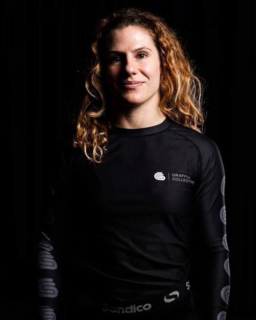Martina Zola in a black rash guard, photographed against a black background